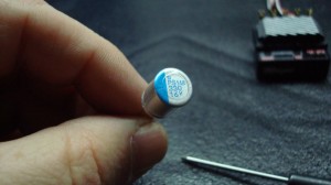 The blue marker indicates the negative leg of the cap.